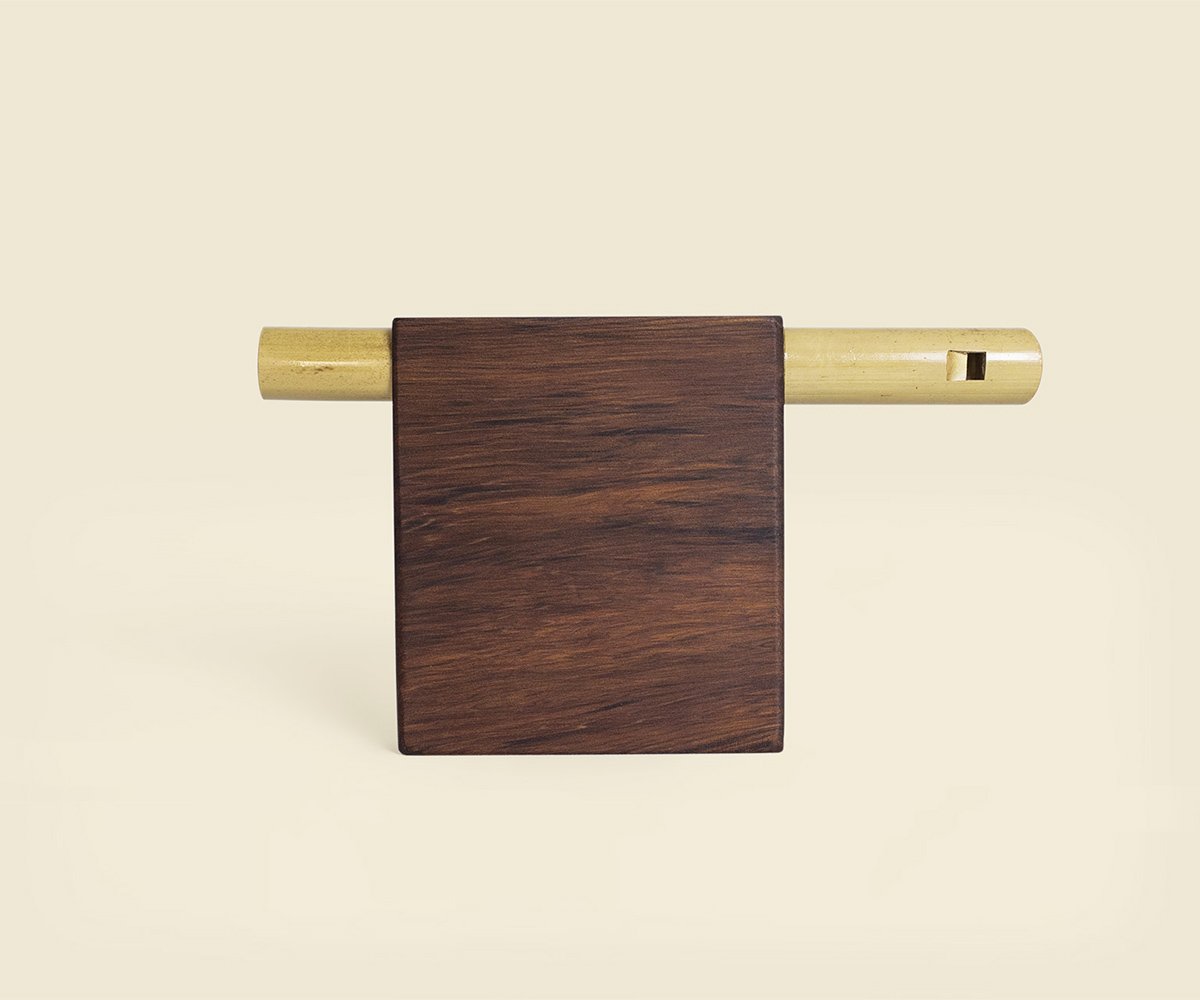 Compact flute from the front: a bamboo tube through a red cedar block